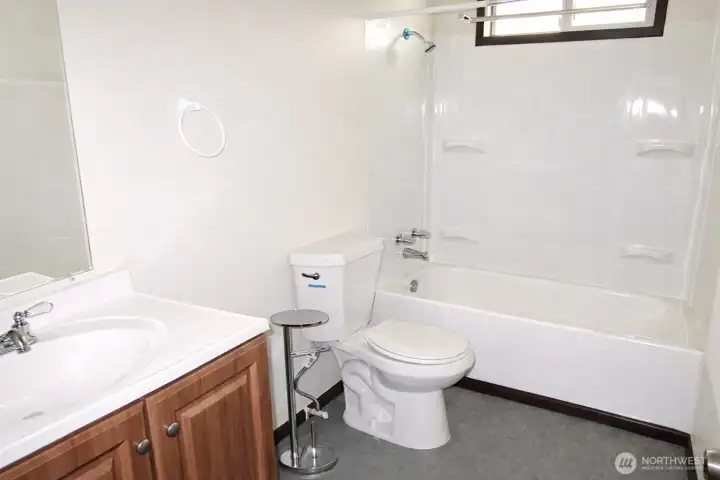 Full bath located conveniently in hallway between all bedrooms and living space. *Photo is from prior to current tenancy, home is fairly cluttered currently*