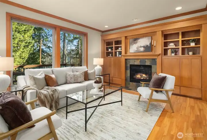 Warm and charming family room with cozy gas fireplace, built-in Maple cabinetry and elegant crown molding throughout. Huge windows overlook green belt and entertaining deck. Warm and charming family room with cozy gas fireplace, built-in Maple cabinetry and elegant crown molding throughout. Huge windows overlook green belt and entertaining deck.