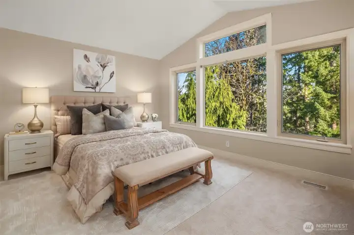 Lovely primary suite with a wall of windows overlooking the private greenbelt. Lovely primary suite with a wall of windows overlooking the private greenbelt.