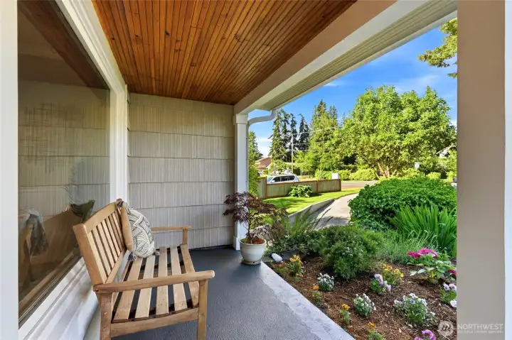 Inviting covered front porch overlooking the landscaped front yard.