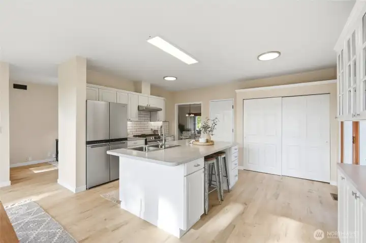 Kitchen with center island, ample storage, and workspace.