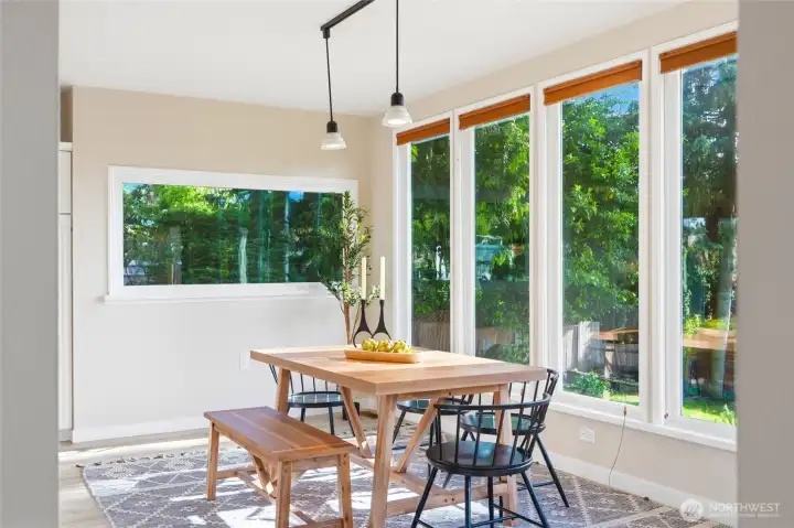 Spacious dining area with backyard views.