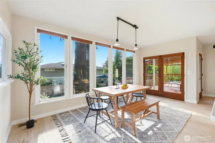 Open dining area that features french doors out to large deck.