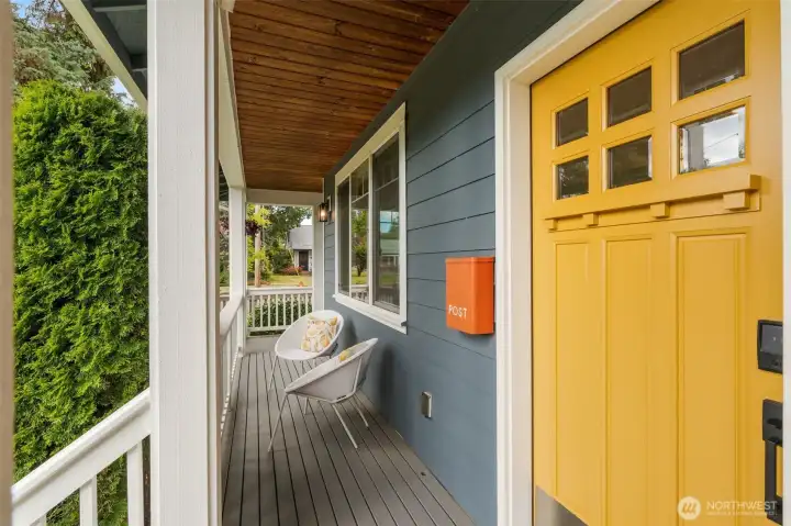 Covered front porch & on trend freshly painted front door.