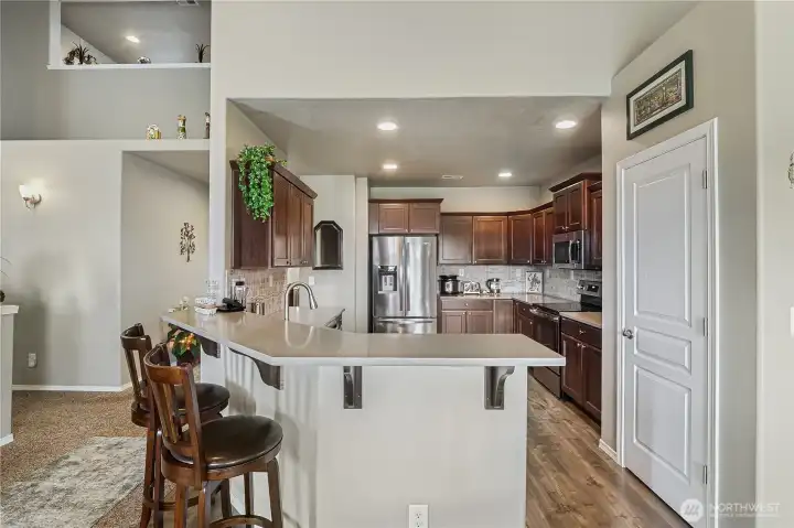 Thoughtfully designed kitchen combines quartz countertops with an open, inviting layout.