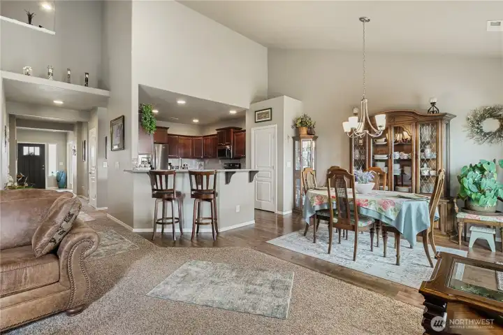 Kitchen flows seamlessly into dining and living spaces.