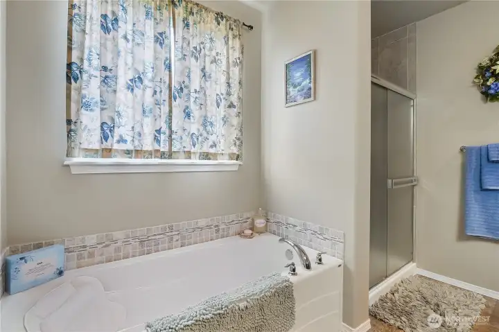 Ensuite bath provides privacy and functionality, with a large soaking tub.