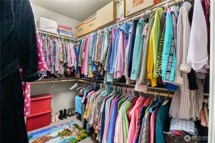 Generous walk-in closet provides organized storage for every season.