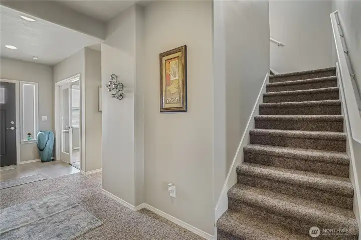 Open staircase connects both levels with style and functionality.