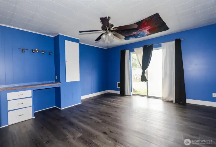 Immense primary bedroom with slider to back yard. Immense primary bedroom with slider to back yard.