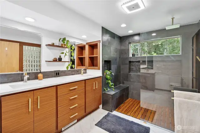 This is a brand new remodeled primary bathroom with Sapele Mahogany custom soft close cabinetry. Brass hardware. Teak removable floors in the walk in shower.