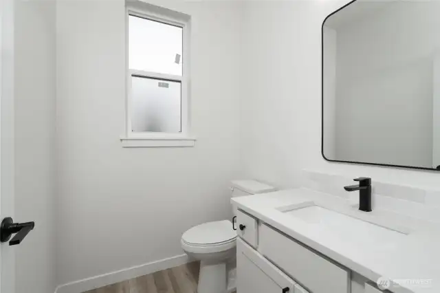 Main level half bath - Pics are of a different 2834 plan. Features and colors may differ.