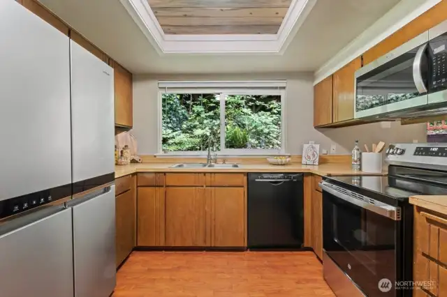 U shaped kitchen with pantry and beautiful nature views