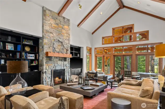Great Room with stone fireplace and impressive beamwork