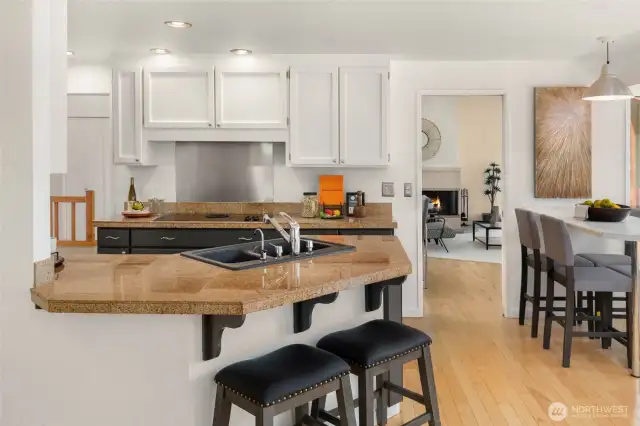 Kitchen with casual breakfast nook looking out to back deck. All nature. No views of neighbors