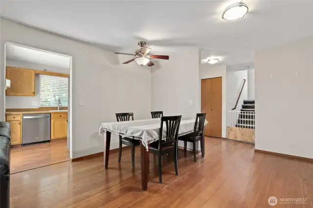 Another view of dining area looking towards kitchen and stairway