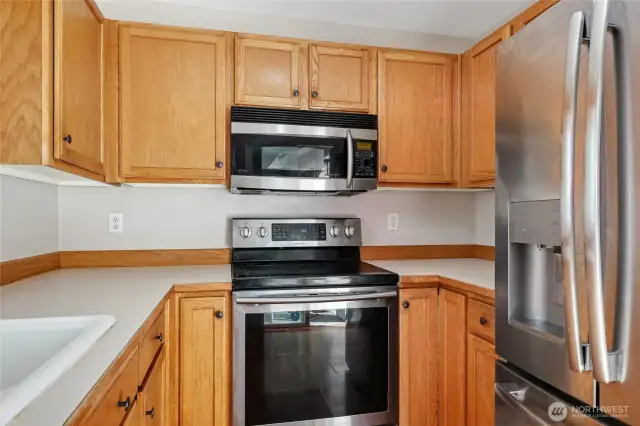 Another view of kitchen showing ss refrigerator.