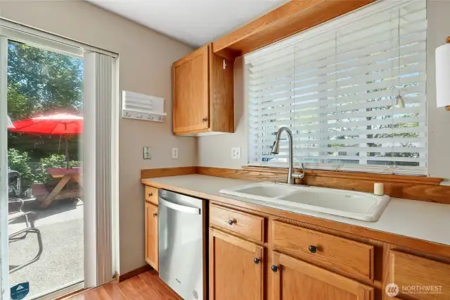 Another view from kitchen showing large sink, sliders off to rear yard patio.