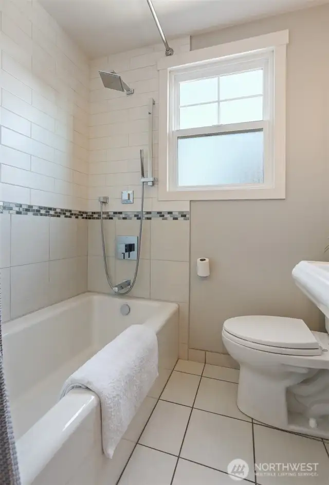 A thoughtfully remodeled main floor bathroom with a clean, inviting aesthetic.