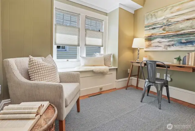 This creative main floor office boasts southern exposure, a built-in bench with storage, and rich fir flooring—an inspiring place to work.