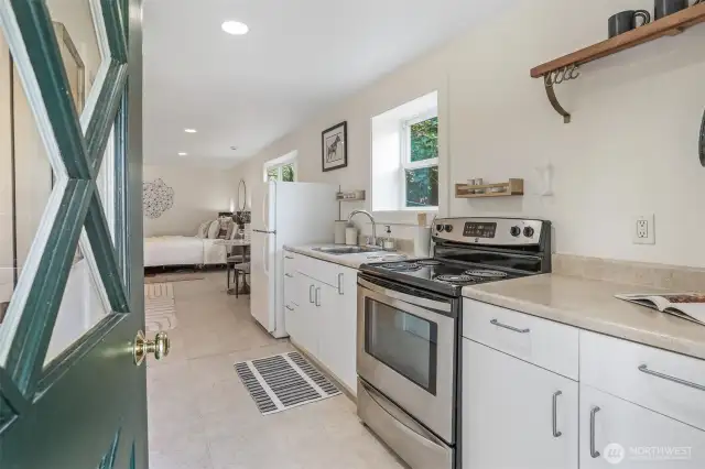 The lower-level studio offers privacy and flexibility with its own entrance, interior and exterior access, a kitchen, and a ¾ bathroom.