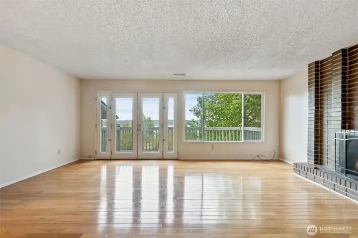 Livingroom with Hard wood floors, views of Dyes Inlet and a fire place for those cozy evenings.