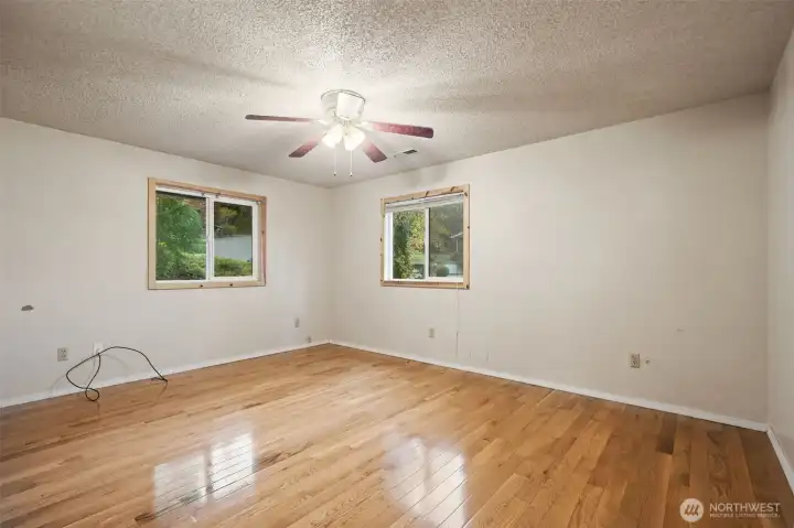 Hardwood floors carry thru the primary bedroom.