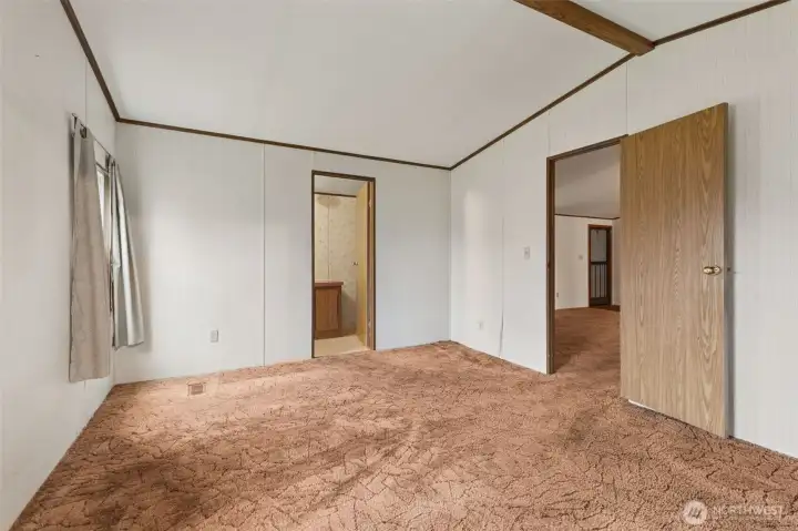 Looking back from closet towards bathroom in primary bedroom.