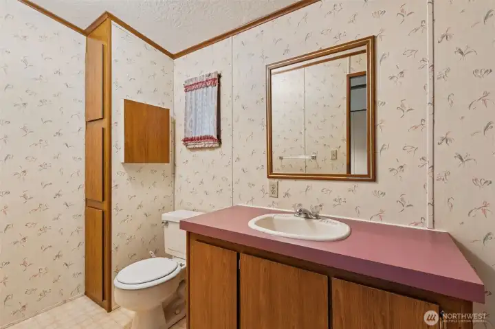 Full attached bathroom in primary suite provides ample storage.