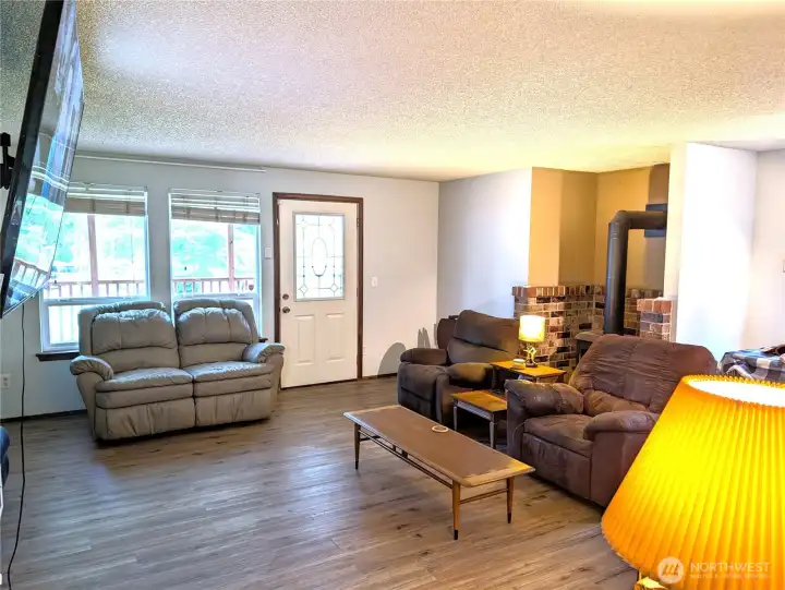 Entry w/laminate flooring & gas fireplace in family room.