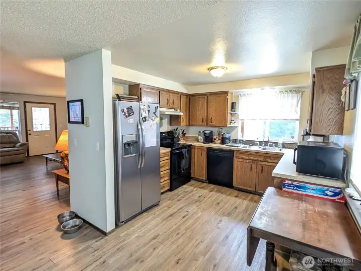 The covered front deck, entry, family room, kitchen, dining area & access to the covered back deck & yard all open to eachother to flow from the front to the back of the home.