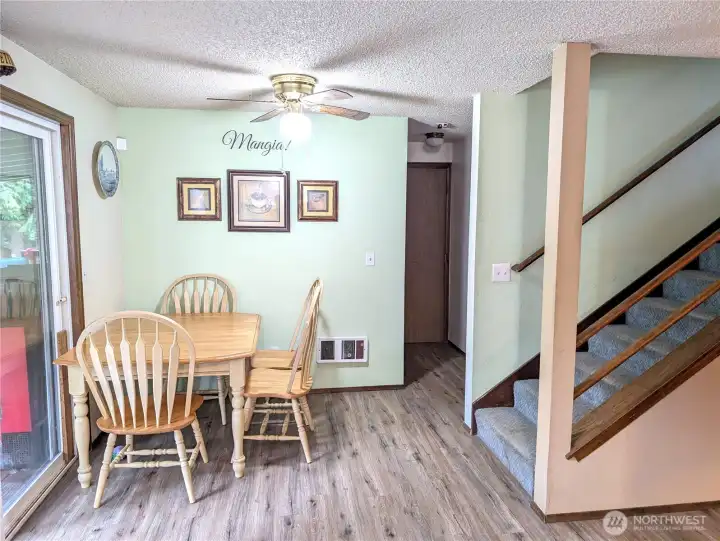 Dining room.  Hallway leads to the half bath on main, big office/den/optional 6th bedroom & garage.  Back yard through slider to the left.  Heading upstairs to the right.