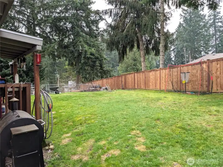 Covered deck to the left, fire pit straight ahead.  Pleanty of room to play.