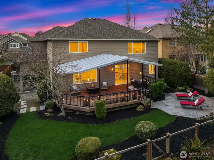 The outdoor spaces include a patio, generous covered deck, and fully fenced, landscaped yard with lawn and a storage shed - offering an ideal setting to take in the peaceful greenbelt backdrop, whether entertaining, unwinding in the evenings, or simply enjoying the natural beauty of the Pacific Northwest.