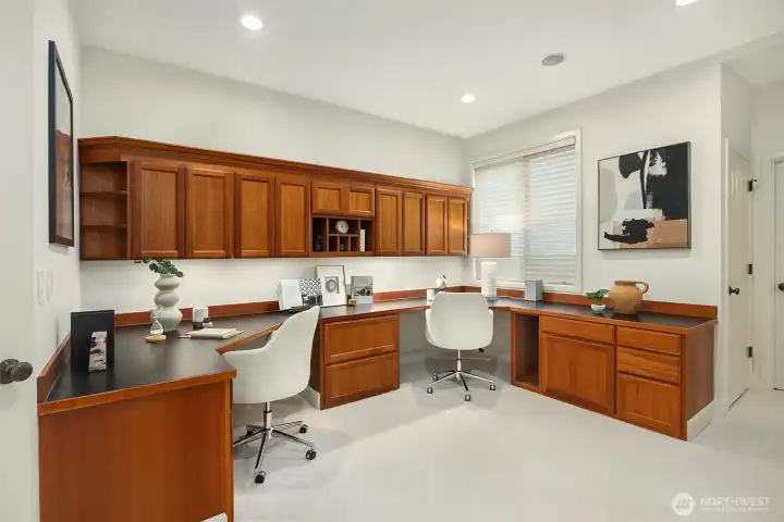 The main-floor den features beautifully crafted custom built-ins, creating a refined work-from-home space, with the flexibility to serve as a guest room if desired. A connected 3/4 bath enhances the functionality of the main level for visitors or extended stays.