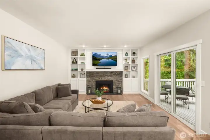 Family room has an upgraded gas fireplace with a custom mantle and built-ins