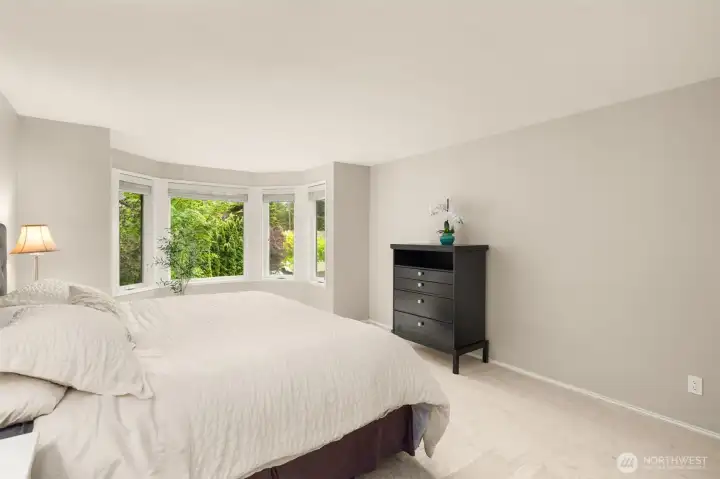 Natural light and calming finishes make the primary suite feel serene and inviting.