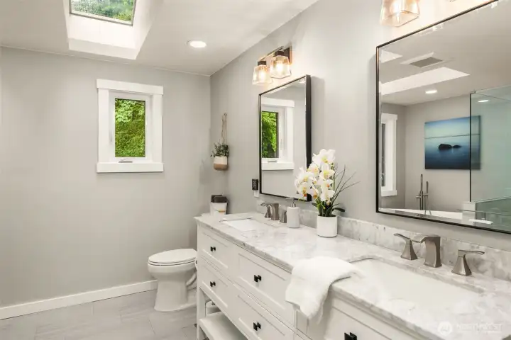 Primary suite has a custom designed bathroom complete with heated floors
