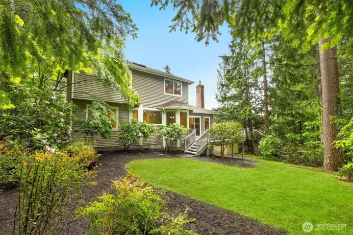 Expansive, lush yard offers endless opportunities for gardening, play, or hosting gatherings in a private setting