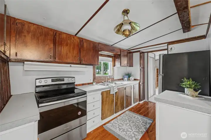 Kitchne has stainless steel refridgerator & oven.