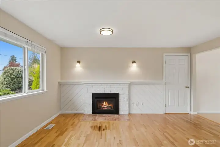 White brick fireplace with gas insert insert…perfect for chilly evenings. Designer lighting.
