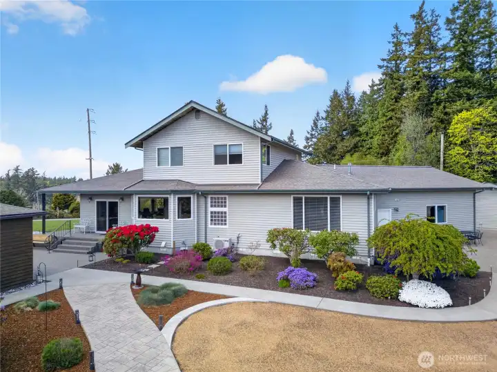 Beautifully landscaped home with vibrant gardens, inviting outdoor spaces, and a spacious layout designed for comfortable living and entertaining.