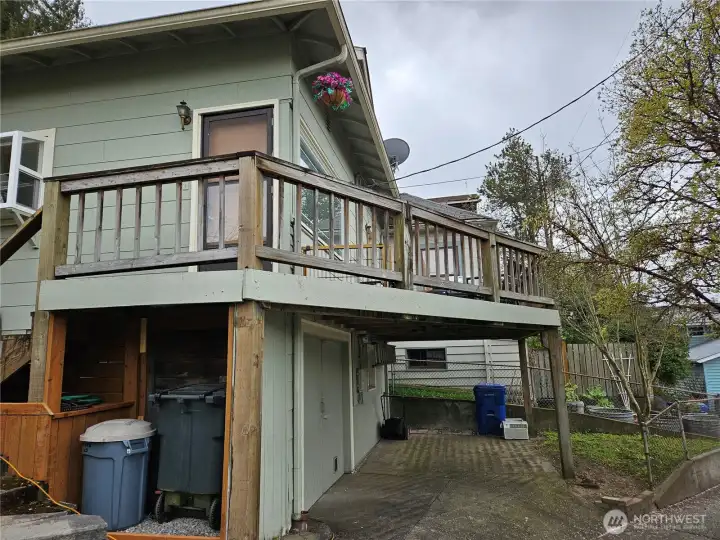Back yard, kitchen bay window, deck and garage