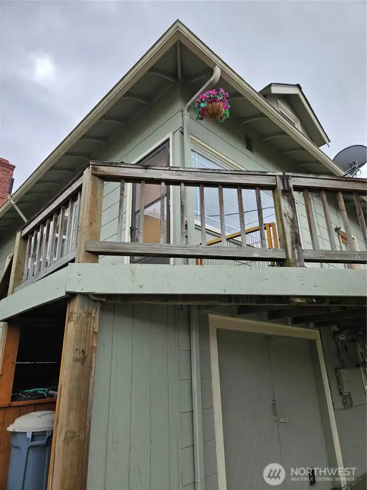 Back looking at kitchen and deck and garage door