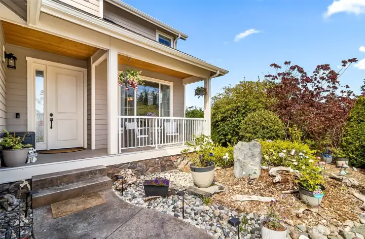 low maintenance front gaarden beds and a cozy front porch for relaxing on.....come in and take a look