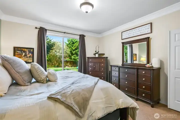 Large primary bedroom located on the main floor offers plenty of room for your oversized furniture and your very own slider to the deck!