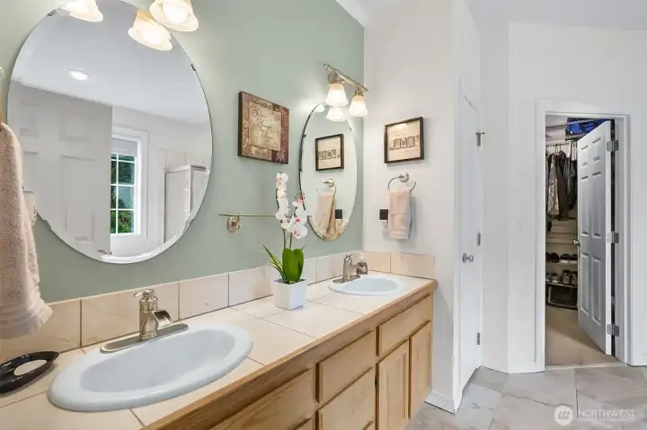 Primary ensuite features double vanity sinks - large walk in closet