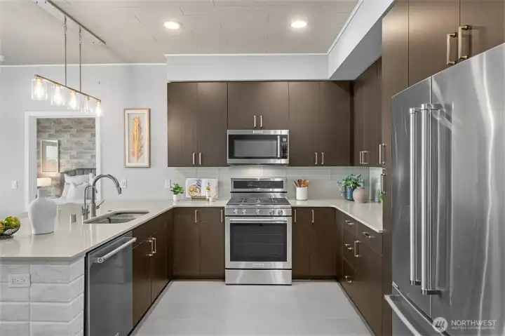 Gorgeous kitchen with modern finishes, 6-burner gas stove, glass tile backsplash, quartz countertops and eating bar. Notice the custom accent tile on the end of the countertop and the ceilings! Gorgeous kitchen with modern finishes, 6-burner gas stove, glass tile backsplash, quartz countertops and eating bar. Notice the custom accent tile on the end of the countertop and the ceilings!