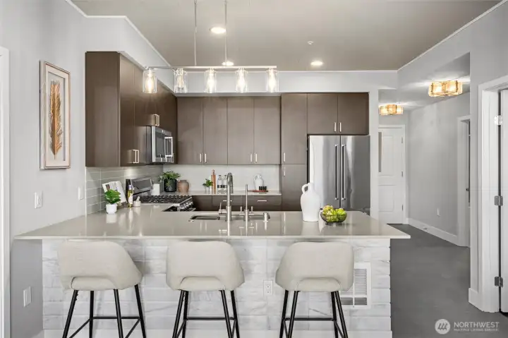 Gorgeous kitchen with modern finishes, 6-burner gas stove, glass tile backsplash, quartz countertops and eating bar. Notice the custom accent tile on the end of the countertop and the ceilings! Gorgeous kitchen with modern finishes, 6-burner gas stove, glass tile backsplash, quartz countertops and eating bar. Notice the custom accent tile on the end of the countertop and the ceilings!