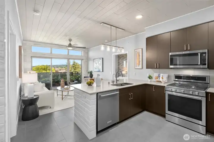 Gorgeous kitchen with modern finishes, 6-burner gas stove, glass tile backsplash, quartz countertops and eating bar. Notice the custom accent tile on the end of the countertop and the ceilings! Gorgeous kitchen with modern finishes, 6-burner gas stove, glass tile backsplash, quartz countertops and eating bar. Notice the custom accent tile on the end of the countertop and the ceilings!